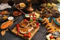 Overhead of dinner table. Assorted delicious grilled barbecue me Royalty Free Stock Photo