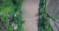 Overhead Drone shot of tropical landscape of Indonesia with river, rice field and countryside