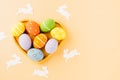 Overhead easter eggs with rabbit paper cut in shape heart isolated on pastel background Royalty Free Stock Photo