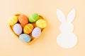 Overhead easter eggs with rabbit paper cut in shape heart isolated on pastel background Royalty Free Stock Photo