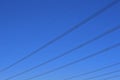 OVERHEAD ELECTRICAL CABLES AGAINST A DEEP BLUE SKY Royalty Free Stock Photo