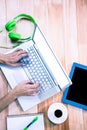 Overhead of feminine hands typing on laptop