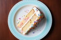 Overhead flat lay view of a slice of birthday party celebration cake