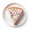 Overhead view of a slice of birthday celebration cake isolated against a plain white background