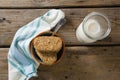 Granola bar and milk with napkin on wooden table Royalty Free Stock Photo