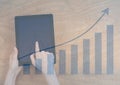 Overhead of hands with tablet and blue graph overlay Royalty Free Stock Photo