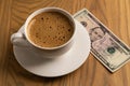 Overhead Hot Coffee Cup and Five Dollar Bill on Wooden Table Royalty Free Stock Photo