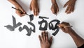 Diverse Hands United in the Art of Calligraphy Royalty Free Stock Photo