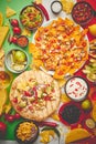 An overhead photo of an assortment of many different Mexican foods on a table