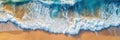 Overhead photo of crashing waves on the shoreline. Tropical beach surf. Abstract aerial ocean view.