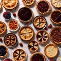 Overhead photo of different pies, tarts, and deserts on white marble table