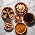 Overhead photo of different pies, tarts, and deserts on white marble table