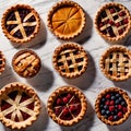 Overhead photo of different pies, tarts, and deserts on white marble table