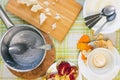 An overhead photo of dirty bowls with oatmeal porridge leftovers, half of pomegranate, tea spoons and knife, empty saucepan, woode Royalty Free Stock Photo