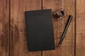 An overhead photo mockup of a black book with a fountain pen, an ink well, and a place for text Royalty Free Stock Photo