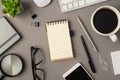 Overhead photo of notebook keyboard computer mouse magnifier pens phone plant glasses cup of coffee and paperclips isolated on the Royalty Free Stock Photo