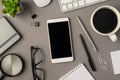 Overhead photo of notebook keyboard computer mouse magnifier pens phone plant glasses cup of coffee and paperclips isolated on the Royalty Free Stock Photo