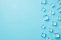 Overhead photo of pile of cubes ice and drops isolated on the blue background with empty space Royalty Free Stock Photo