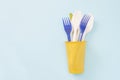 An overhead photo of plastic garbage. Plastic disposable tableware, spoon, forks in cup. Zero waste, environmental pollution. Save Royalty Free Stock Photo