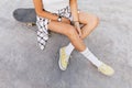 Overhead photo of tanned caucasian girl chilling in skate park after training. Magnificent woman wea Royalty Free Stock Photo