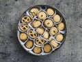 An overhead photo of a tin can of Danish butter cookies, shot from above on a light background texture with a place for text Royalty Free Stock Photo