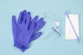 An overhead photo of the vaginal speculum, white napkin, medicine gloves and spatula. Medical plastic tool for holding open the va