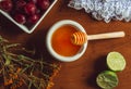 Overhead photograph of still life of organic food, honey, grapes and flowers. Cold remedy, honey and lemon.