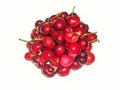 Overhead of a pile of red ripe shiny fresh sweet cherries isolated on white background Royalty Free Stock Photo