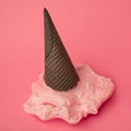 Overhead pink plastic ice cream on chocolate black cone on paste