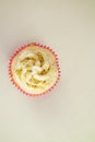 Overhead of pistachio vanilla cupcake with space for text Royalty Free Stock Photo