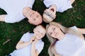 Overhead portrait on family lying on grass in park. Royalty Free Stock Photo