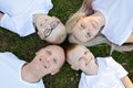 Overhead portrait on family lying on grass in park Royalty Free Stock Photo