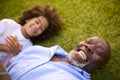 Overhead Portrait Shot Of Loving Grandfather And Grandson Lying On Grass Laughing Together Royalty Free Stock Photo