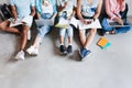 Overhead portrait of young people with laptops and smartphones, sitting together on the floor. Students writing lectures Royalty Free Stock Photo