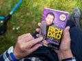 Overhead POV view of senior male hand hodling in had reading the iconic book Royalty Free Stock Photo