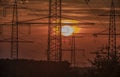 Overhead power cables in front of rising sun Royalty Free Stock Photo