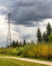 Overhead power line tower with dramatic rain cloud background