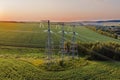 Overhead power line transmission tower at sunset Royalty Free Stock Photo