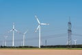 Overhead power lines and wind energy plants Royalty Free Stock Photo