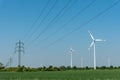 Overhead power lines and wind energy plants Royalty Free Stock Photo