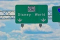 Overhead road direction signs showing way to Disney World