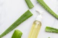 Overhead shot of aloe vera bottle surrounded by natural green aloe vera leaves Royalty Free Stock Photo