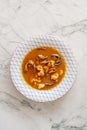 Overhead shot of a bowl of thick red seafood stew