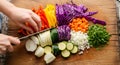 Hands chopping fresh colorful vegetables on a wooden cutting board for a healthy meal Royalty Free Stock Photo