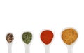 Overhead shot of a collection of spices on spoons isolated on white background Royalty Free Stock Photo