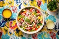 overhead shot: colorful greek salad bowl, dressing on side Royalty Free Stock Photo