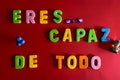 Overhead shot of colorful yellow toy letters eres capaz de todo