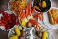 Overhead shot of cooked seafood and corn on plates on the grungy table