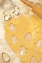 Overhead shot of a cookie dough being cut in shapes of eggs and Easter bunnies Royalty Free Stock Photo