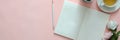 Overhead shot of creative home office with open diary notebook on pink table Royalty Free Stock Photo